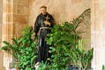 Monk statue at the cross, cloister of St. Francis, Alghero, Sardinia.