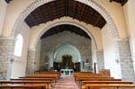 The nave with stone arches, Santa Maria della Neve, Arzachena, Sardinia.