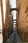 Bosa, Via Carmine, support arches in the alley, Sardinia.