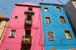 Bosa, Vicolo della Scuda, pink and blue front facade, Sardinia.