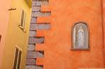 Bosa, Vicolo della Scuda, Virgin embedded in a wall, Sardinia.