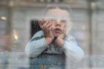 Olbia, child behind the steamy window, Sardinia.
