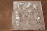 Oristano, Corso Umberto I, sculptures of heads laughing, Sardinia.
