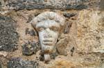 Basilica della Santissima Trinita di Saccargia, head carved in a wall, Sardinia.