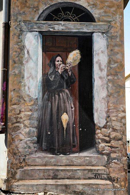 Fonni, wool spinner on the doorstep, mural - Sardinia