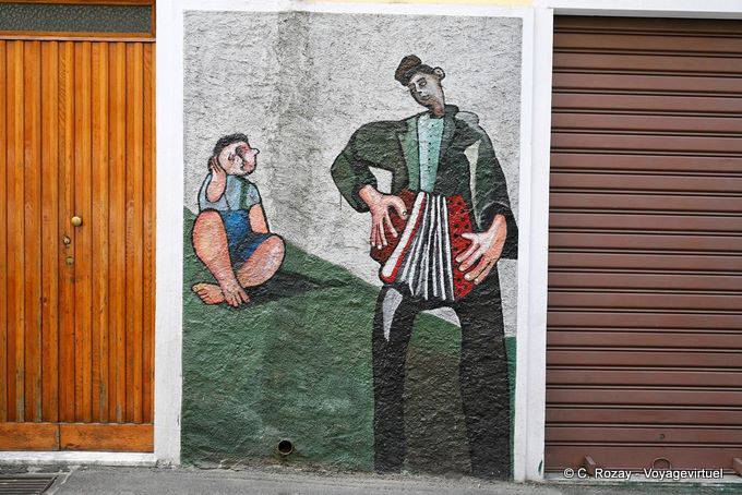 Orgosolo, accordionist and child, murals - Sardinia