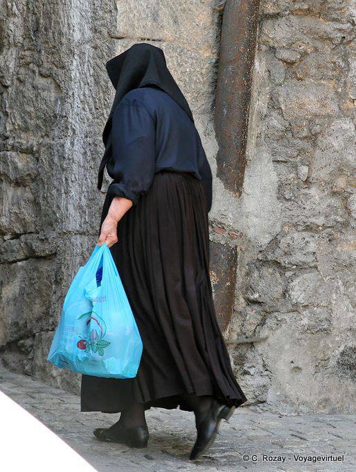 Orgosolo, a woman in traditional costume, rear view - Sardinia