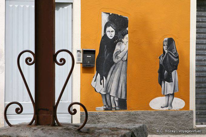 Orgosolo, children play hide and seek, murals - Sardinia
