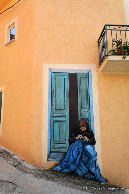 Orgosolo, the seamstress on the no-door, murals - Sardinia