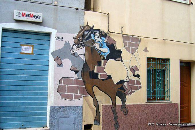 Orgosolo, the rider breaking the wall (Dopo Il Palio), murals - Sardinia
