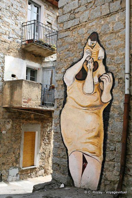 Orgosolo, the woman carrying his child on his shoulders, via d'Azeglio, murals - Sardinia