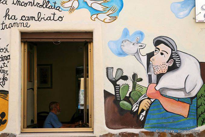 Orgosolo, the peasant and calf watching the doves, murals - Sardinia