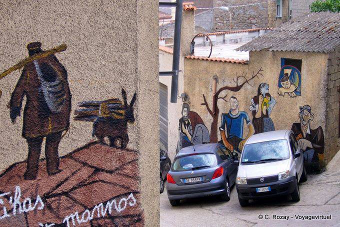 Orgosolo, the pick of wood and a scene of everyday life, murals - Sardinia