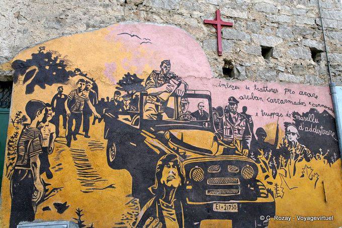 Orgosolo, under the cross, the troops arrived, murals - Sardinia
