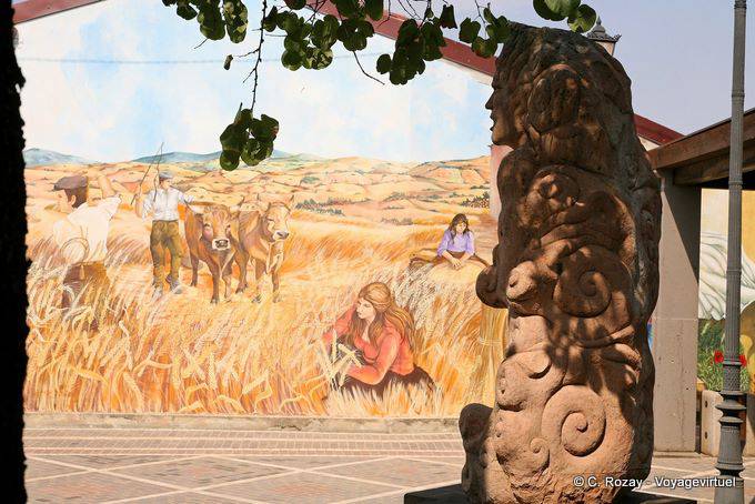Tinnura, Piazza del Municipio, the statue in front of the stage of the crop - Sardinia