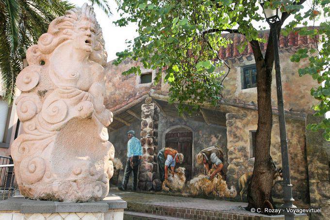 Tinnura, Piazza del Municipio, the monumental statue and painting of sheep shearing - Sardinia