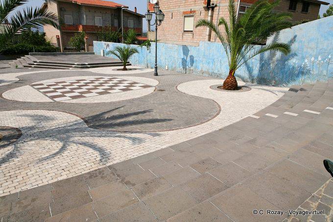 Tinnura, Piazza del Sole, the white marble mosaic of Orosei, married to gray basalt - Sardinia