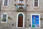 Orgosolo, stone facade at 80 Corso Repubblica, Sardinia.