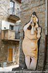 Orgosolo, the woman carrying his child on his shoulders, via d'Azeglio, murals, Sardinia.