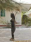 Palms mural and female wooden statue, Senegal.