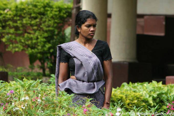 Young woman in gray sari in a garden, Kandy - Sri Lanka Ceylon