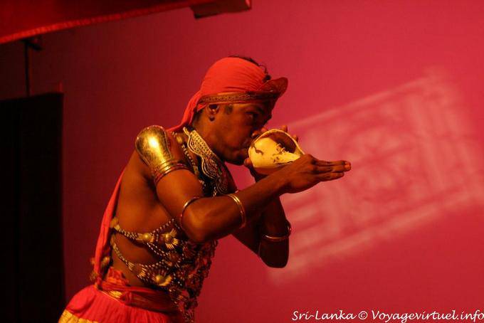 Using the conch like wind instrument, Kandy - Sri Lanka Ceylon