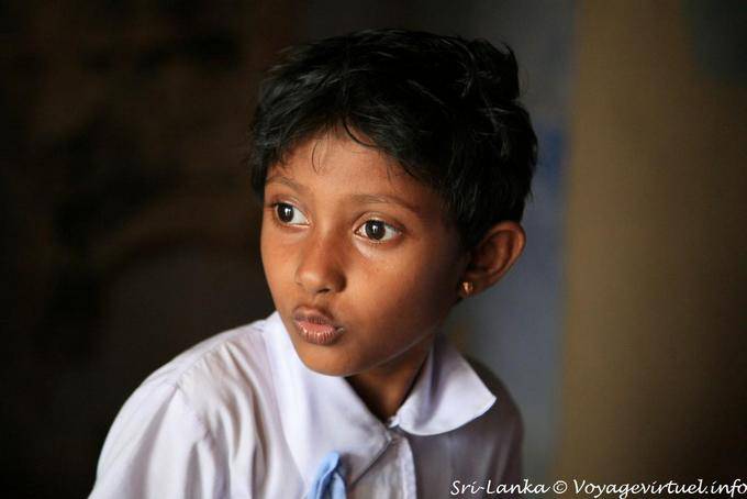 Portrait of young schoolgirl surprised at the temple, Gadaladeniya, Kandy - Sri Lanka Ceylon