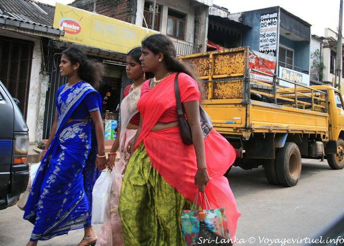 Three young women in saris back racing, street Matale - Sri Lanka Ceylon