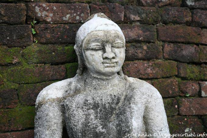 Granite Buddha bust in front of a brick wall, Medirigiriya - Sri Lanka Ceylon