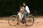 Couple of young Sri Lankan bike on the site of Polonnaruwa, Sri Lanka Ceylon.