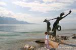 The little girl before the sculpture of Edouard-Marcel Sandoz, a symbol of Vevey, Switzerland.
