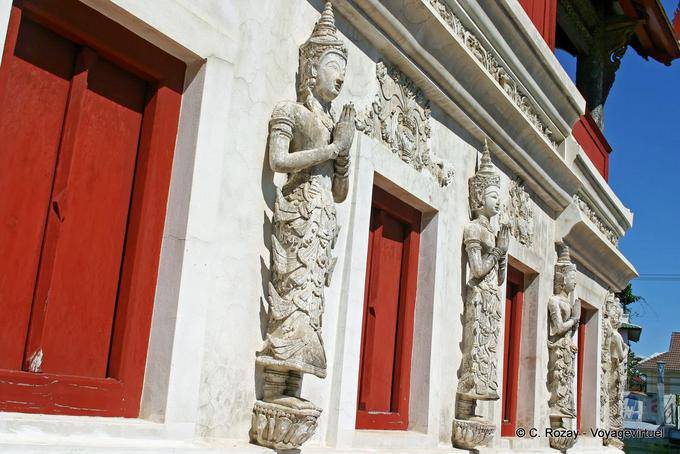 Prayer statues on wall of the temple library, Wat Phra Singh, Chiang Mai - Thailand