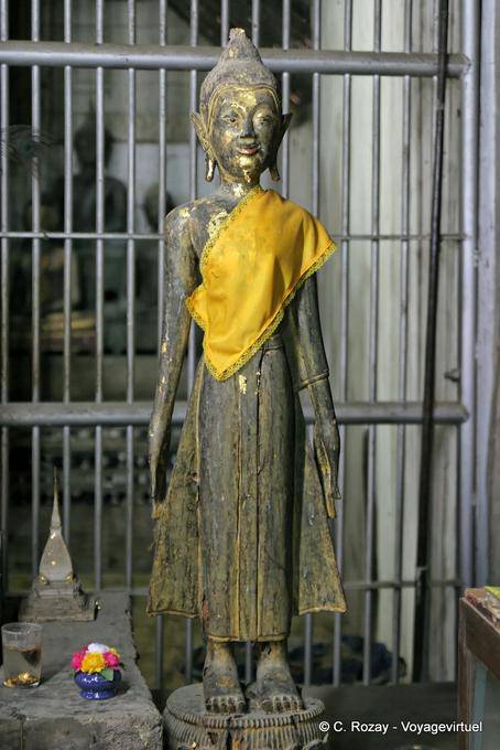 Buddha standing in front of a gate, Wat Phra That Lampang Luang - Thailand