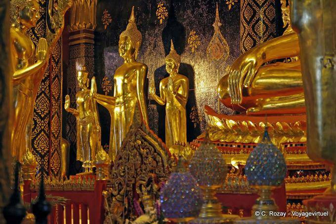 Buddhas standing at the foot of Phra Buddha Chinnarat, Wat Phra Si Rattana Mahatha, Phitsanulok - Thailand