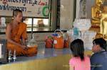 Monk with offerings Wat Choeng Phanan, Ayutthaya, Thailand.