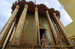 Yakshas two front columns and golden walls, Wat Phra Kaew, Bangkok, Thailand.