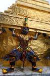 Guards supporting Golden Chedi, Wat Phra Kaew, Bangkok, Thailand.