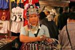 Saleswoman costume trinkets, Chiang Mai, Thailand.