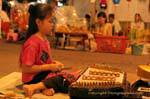 Little girl playing the khim, Chiang Mai, Thailand.