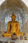 Suan Dok, a Buddha in a niche mirrors, Chiang Mai Temple, Thailand.