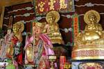 Altar with golden Buddhas, Phuket Town Gypsy, Thailand.