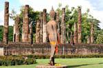 Buddha walking on the bottom of columns, Sukhothai, Wat Sa Si, Thailand.