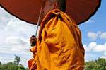 Monk with an umbrella, Sukhothai, Wat Mahathat, Thailand.