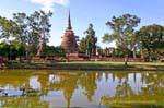 Reflections in the moat, Sukhothai, Wat Mahathat, Thailand.