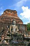 Buddha among the ruins, Sukhothai, Wat Mahathat, Thailand.