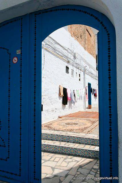 Hammamet, drying laundry and carpet behind the door of the house - Tunisia