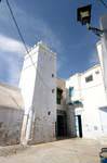 Kairouan, white minaret in the corner of the city, Tunisia.