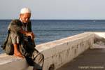 Old fisherman on the wall, Mahdia, Tunisia.