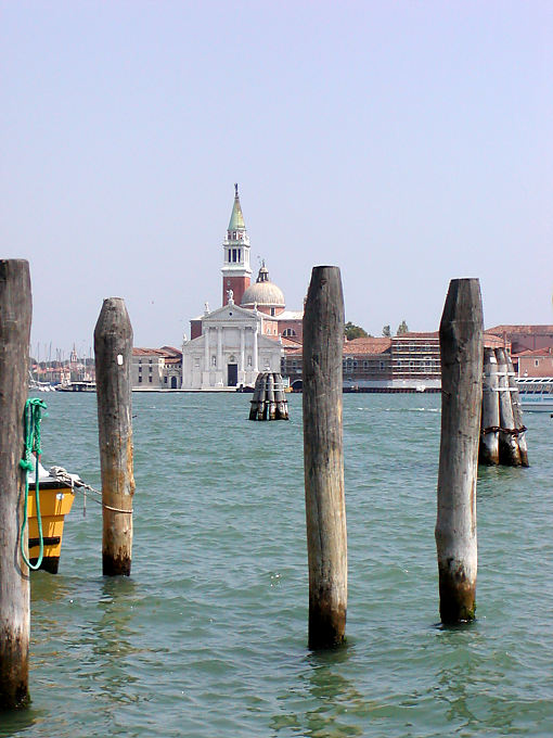 Wooden pillars in the lagoon in front of St. Giorgio Maggiore Basilica, Venice, Italy